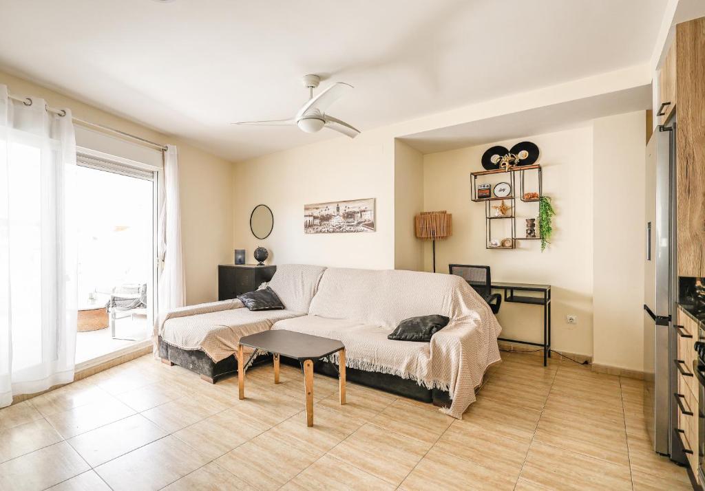 a living room with a couch and a table at Playa Oliva Apartment in Playa