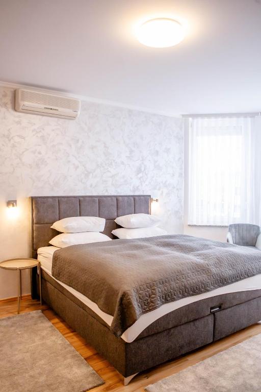 a bedroom with a large bed in a room at Rooms Ikar in Velika Gorica