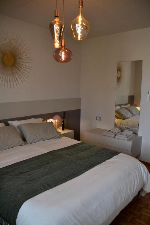 a bedroom with a large bed with a large mirror at Il Ninfeo in Volta Mantovana