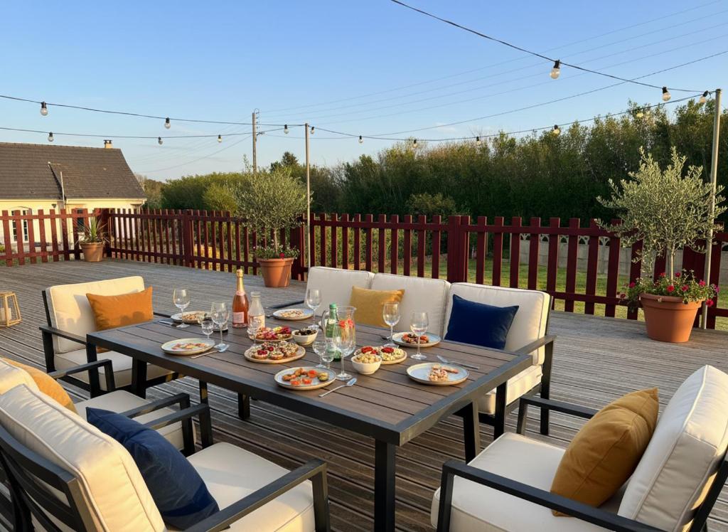a wooden table and chairs on a patio at Villa Margil in Le Tréport