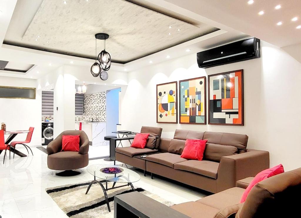 a living room with a couch and a table at Aion Suites 301 in North Legon