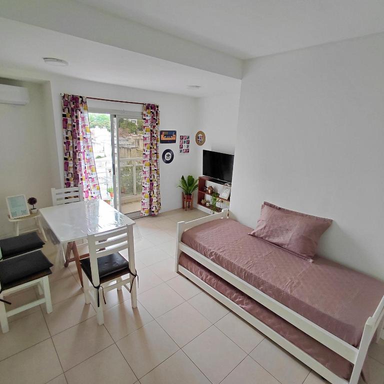 a bedroom with a bed and a desk and a table at departamento temporal 38 y 13 con cochera para AUTO in La Plata