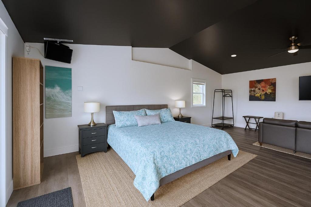 a bedroom with a bed and a television in it at Okangan Sunset Bungalow in Vernon