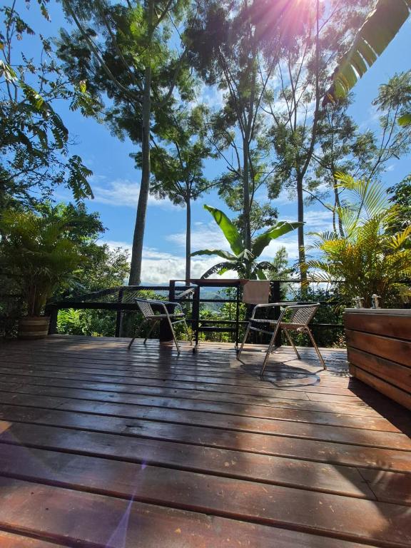 a deck with chairs and a view of the ocean at Cabañas La Arboleda in La Vega