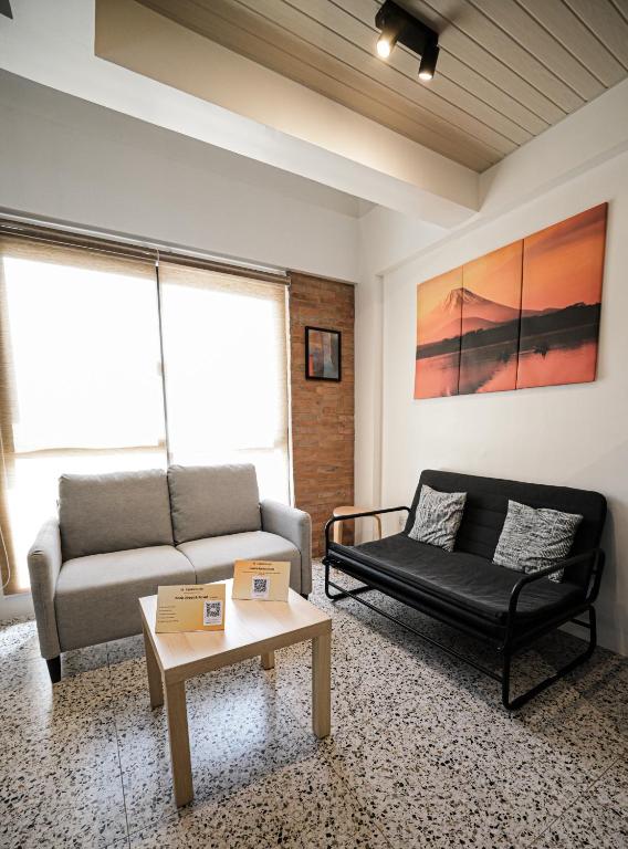 a living room with a couch and a coffee table at Casita Benito Loft A in Sangley Point Naval Station