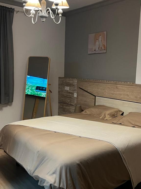 a bedroom with a bed and a painting on a easel at La Loma de Alcalá in Arcos de la Frontera