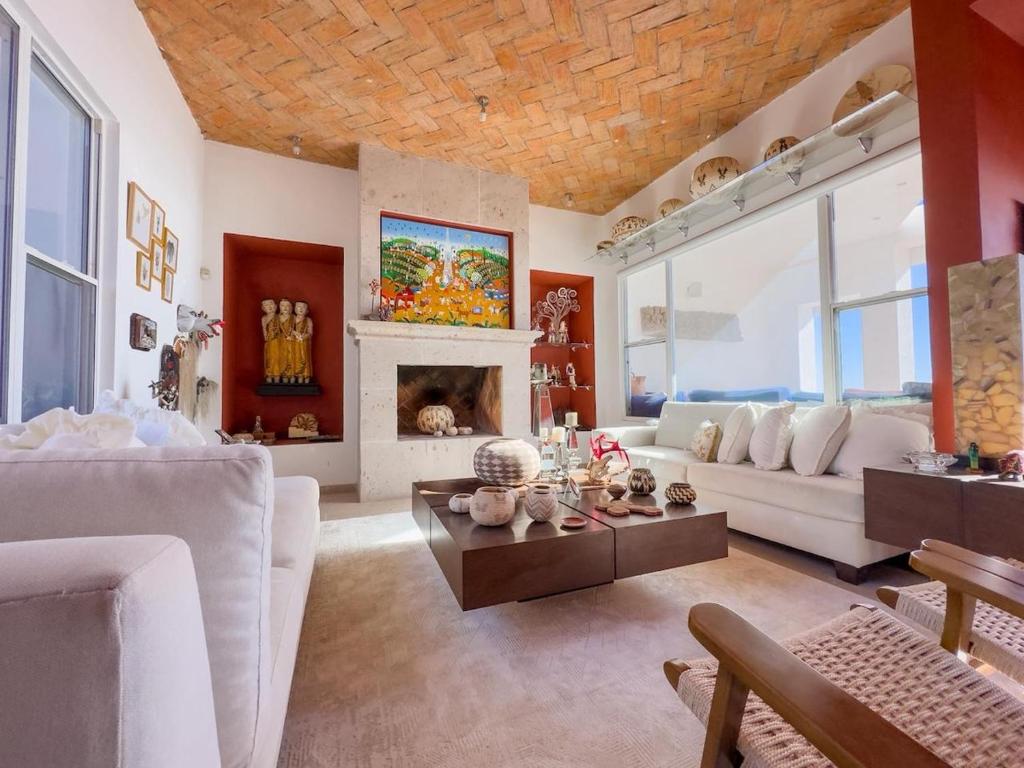 a living room with a couch and a fireplace at Casa Ruma Beachfront Art House in Bahía Kino