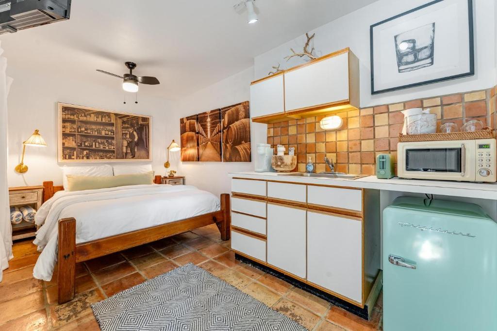 a kitchen with a bed and a microwave at BOOTLEGGER BAY @ Speakeasy Inn Key West! in Key West
