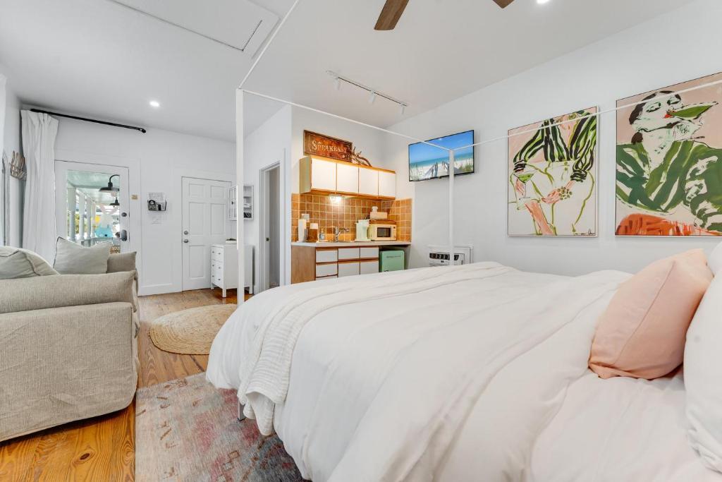 a white bedroom with a large bed and a couch at AFTER HOURS @ Speakeasy Inn Key West! in Key West