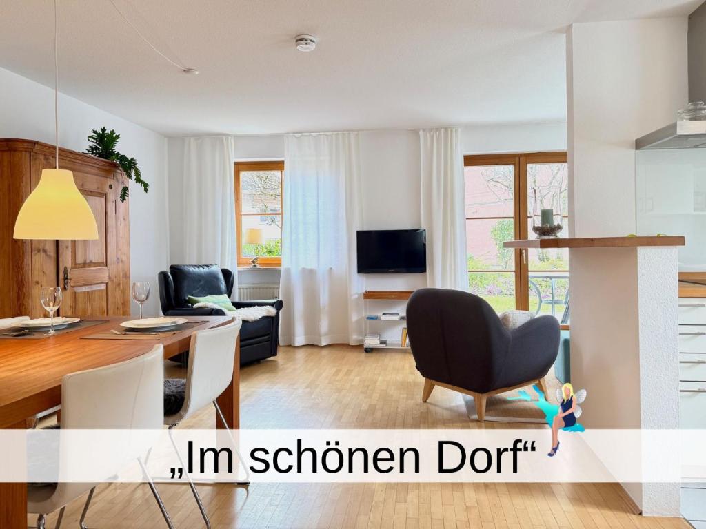 a living room with a table and a dining room at Ferienwohnung Im schönen Dorf - idyllische Lage mit Terrasse und Garten in Lindau-Bodolz