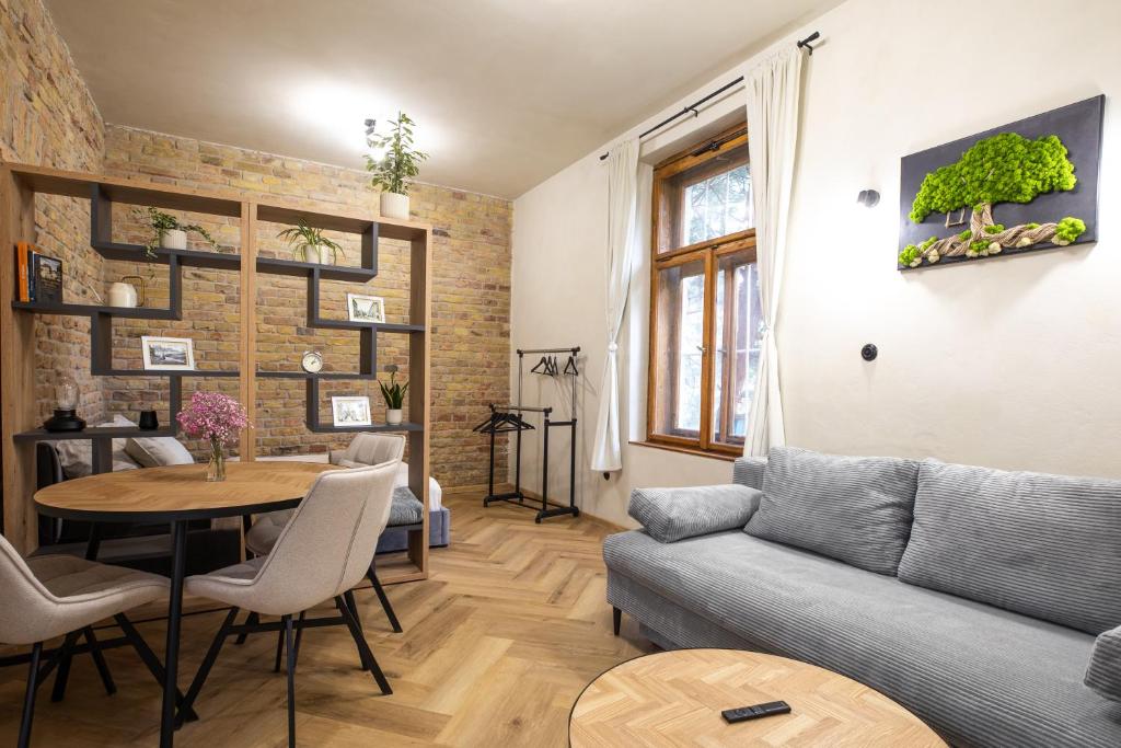 a living room with a couch and a table at Residence 1892 - Apartment 3 in Bratislava
