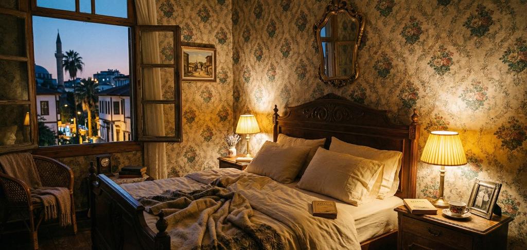 a bedroom with a bed and two lamps and a window at Kule Rezidance Hotel in Seyhan