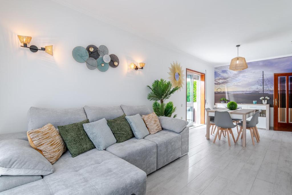 a living room with a couch and a table at Sunset Terrace House by Destiny Houses in Esmoriz