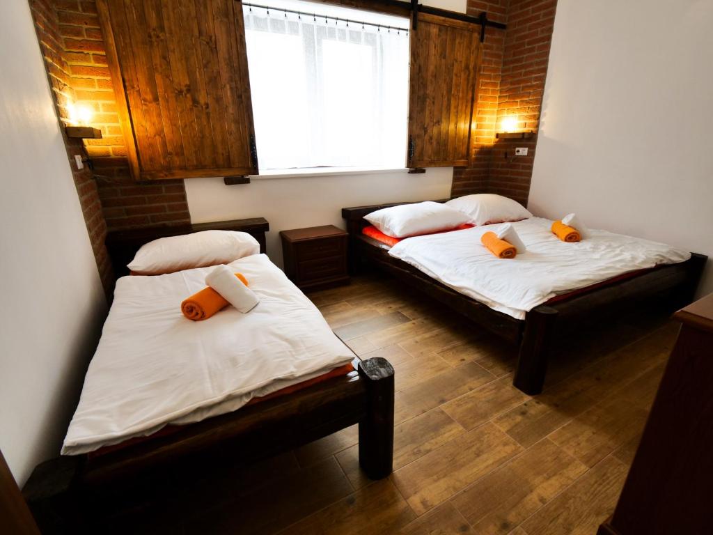 two beds in a small room with a window at Apartmány 13 Přízemí 2 in Seč