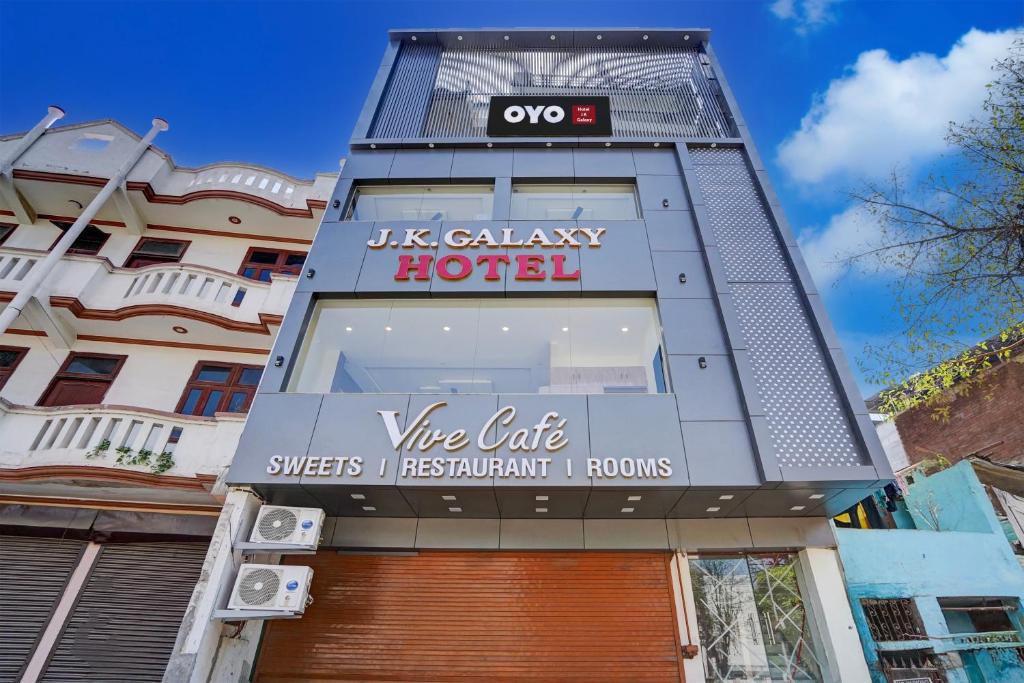 a building with a sign for a luxury hotel at Hotel O J K Galaxy Hotel in Juhi Bari
