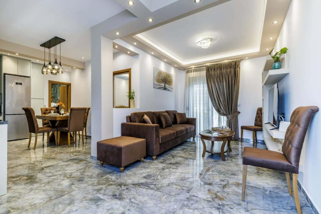 a living room with a couch and a table at The Hidden Gem Skopelos - Elegant Island Retreat in Skopelos Town