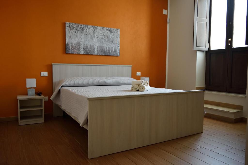 a bedroom with a bed with a teddy bear on it at La casa di Bice alloggio 1 in Cassibile