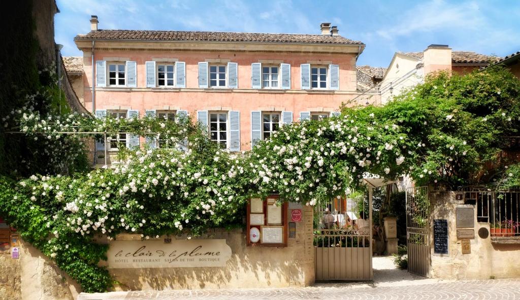 a flowering tree in front of a building at Le Clair de la Plume - Les Collectionneurs in Grignan