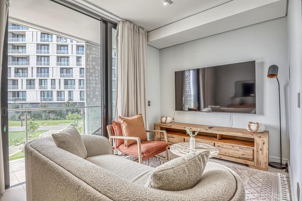 a living room with a couch and a tv at Caica Executives at Ellipse 4103 in Midrand