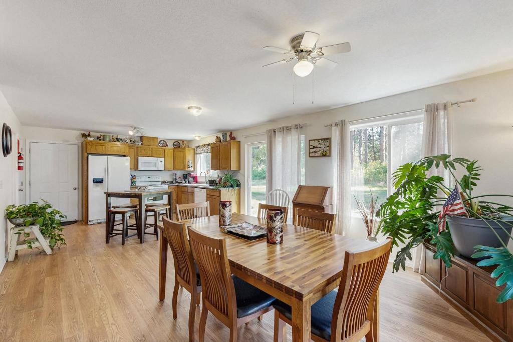 a kitchen and dining room with a wooden table and chairs at 1 Mi to Boat Launch! Lake-View Chiloquin Retreat in Chiloquin