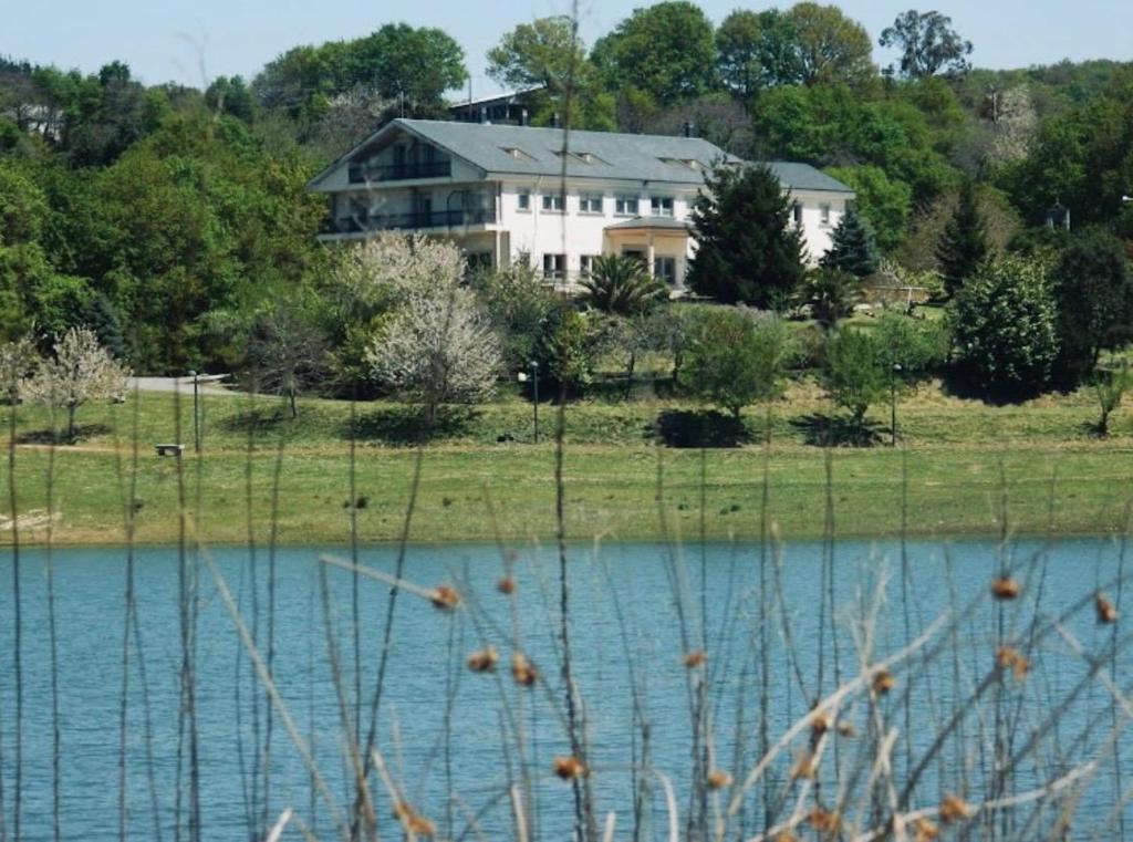 a house on a hill next to a body of water at Hermida Rural in Eirejalba