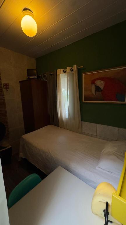 a hotel room with two beds and a table and a desk at Espaço Nabucodonosor in Recife
