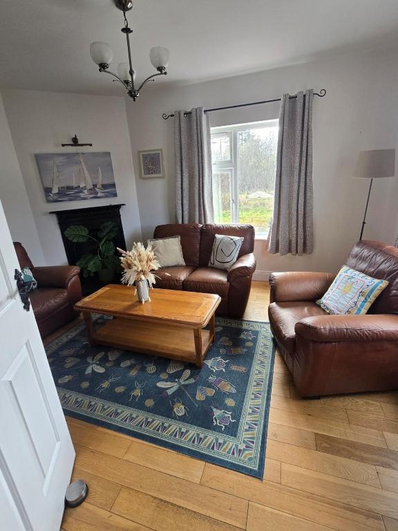 a living room with couches and a coffee table at The Bungalow Killybegs in Killybegs