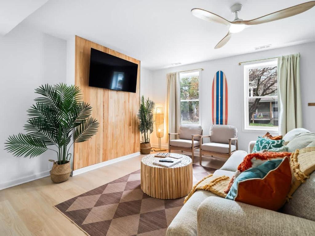 a living room with a couch and a tv at Hot Tub 5 Mins from Cedar Point Modern Updates in Sandusky