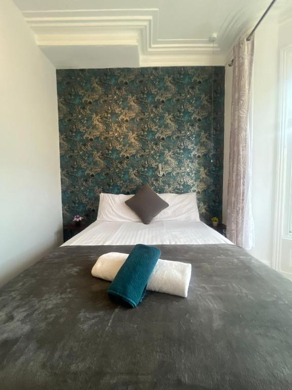a bedroom with a bed with two towels on it at Mayfair hotel Blackpool city centre in Blackpool