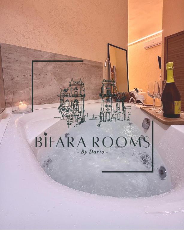 a bath tub with a sign that reads herzzona rooms at Bìfara Rooms in Palermo