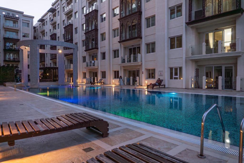 a swimming pool in the middle of a building at Copper Living in Muscat
