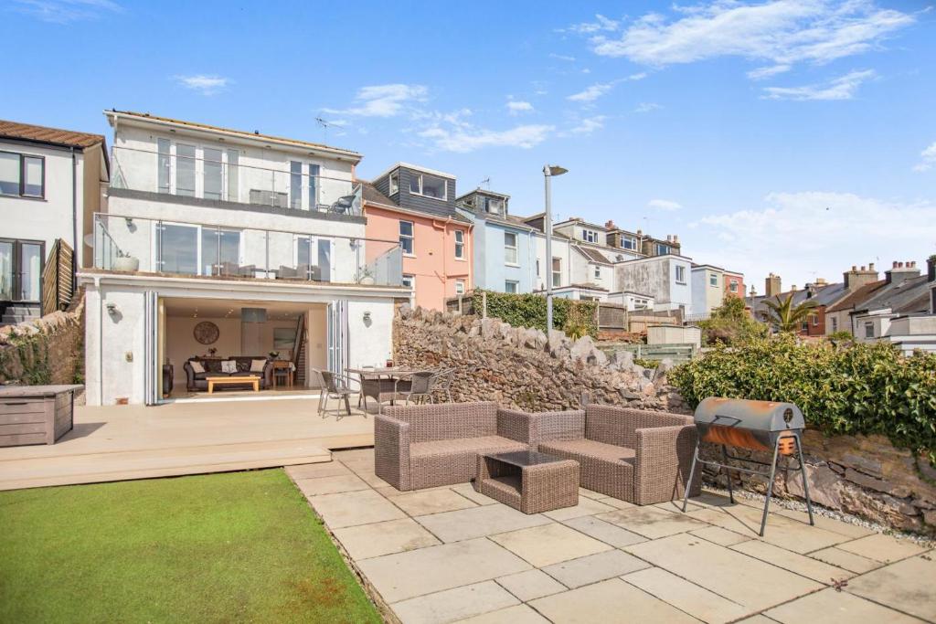 a house with a patio and a backyard with a lawn at 3 Bed in Brixham oc-57892 in Brixham