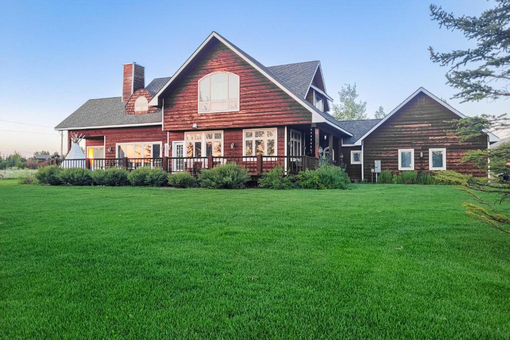 a large house with a large yard with green grass at Fun w/ Family! Mtn-View Gem w/ Deck in Driggs in Driggs