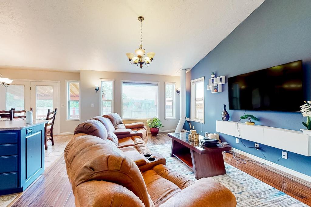 a large living room with a large couch and a tv at Hike, Golf & Explore: Driggs Home w/ Patio & Grill in Driggs