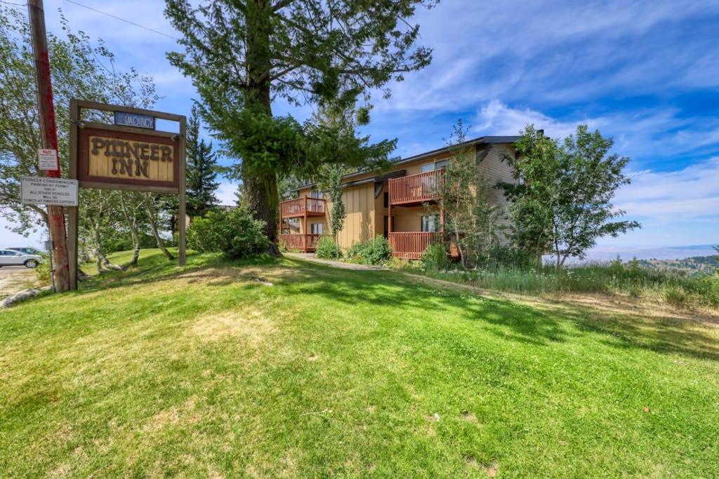 a sign in the grass in front of a building at Slope-Side Getaway Deck Pool Table Views in Boise