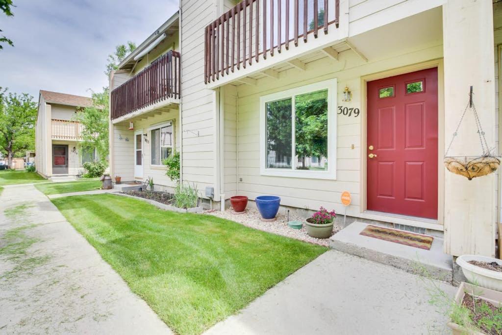 a red door on a house with a yard at Private Townhome - Mountain Views & 2 Baths in Boise