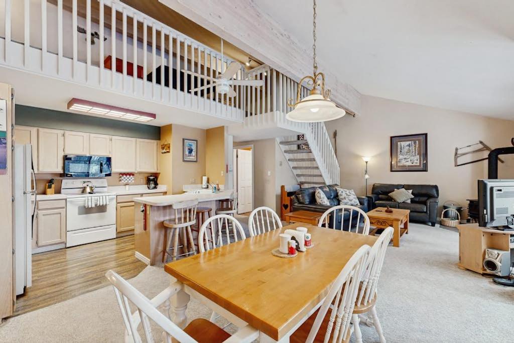 a kitchen and living room with a wooden table and chairs at McCall Mountain Condo Pool Sauna Deck in McCall