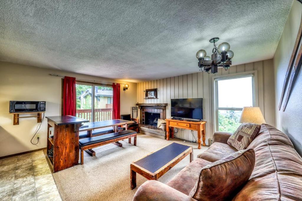 a living room with a couch and a tv at Mountain Retreat Slope Access 2 Decks in Boise