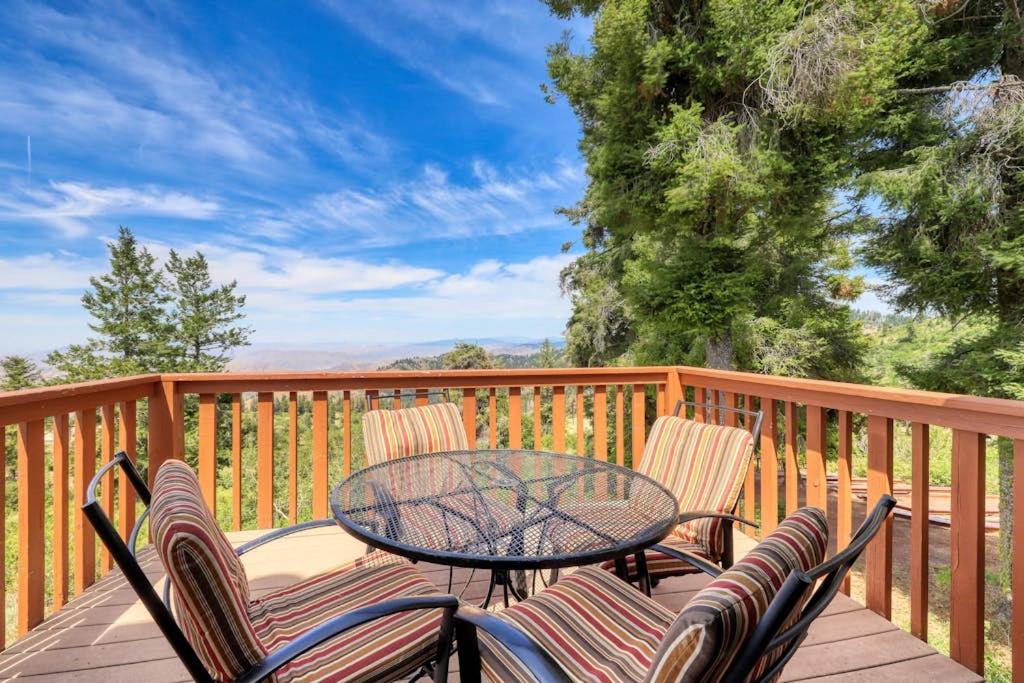 a patio with a table and chairs on a deck at Mountain Condo Ski Access & Sunset Deck in Boise