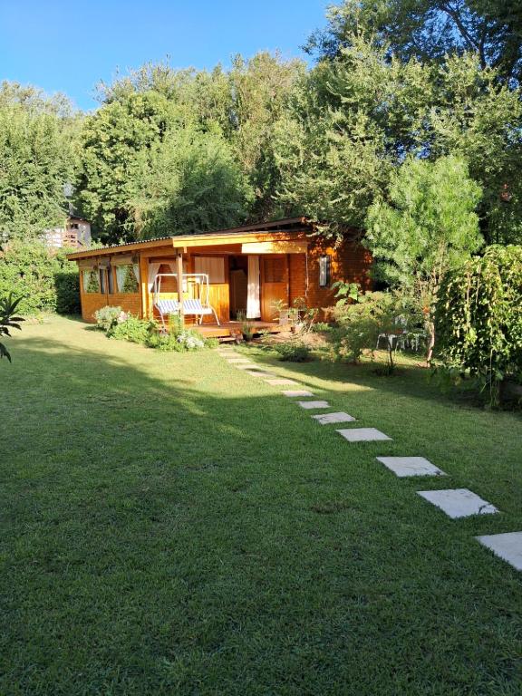 a small house with a lawn in front of it at El Druida 3 in Villa General Belgrano
