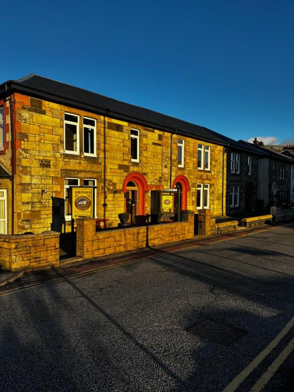 a brick building on the side of a street at Hamilton House Guest House in Oban