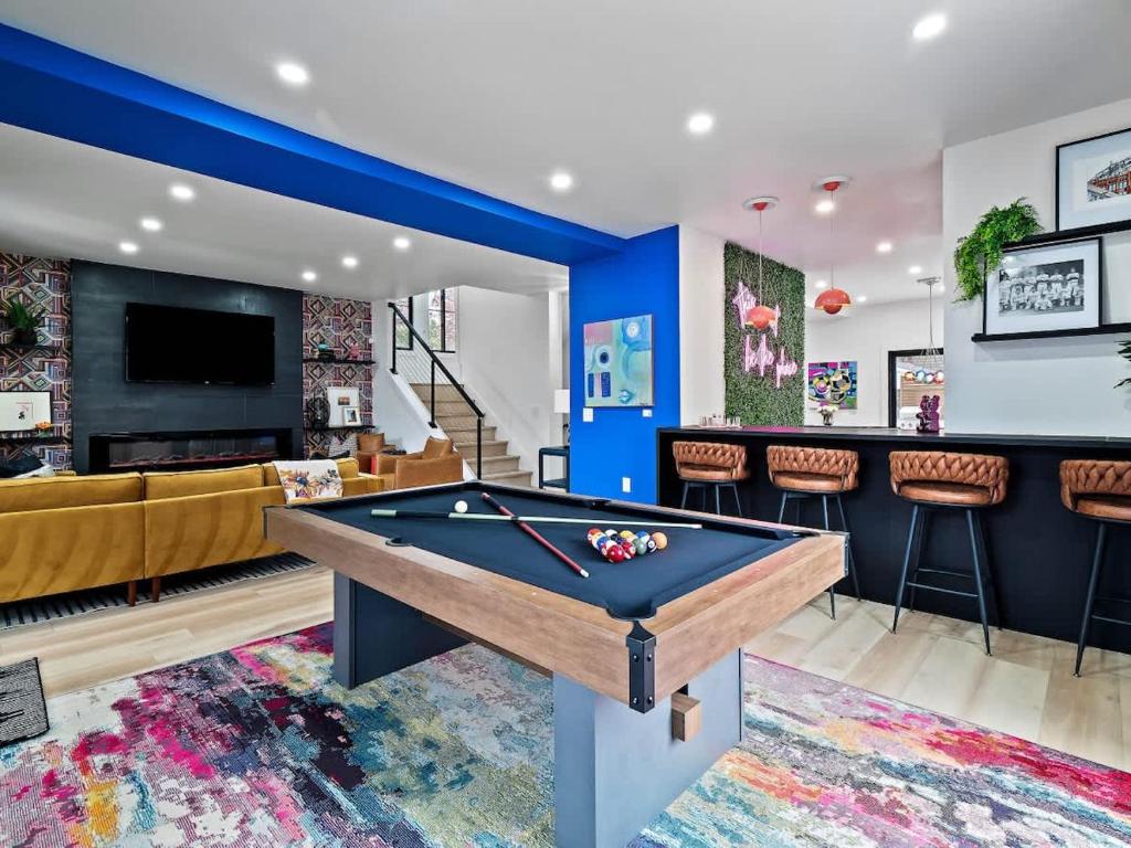 a living room with a pool table and a bar at PoolTable - Hot Tub - FirePit - Games - Bunk Slide - Wet Bar in Akron