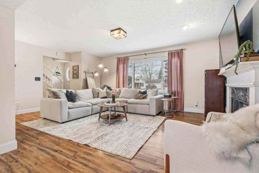 a living room with two couches and a fireplace at Spacious Northfield 4BR Escape near Cuyahoga Valley in Northfield