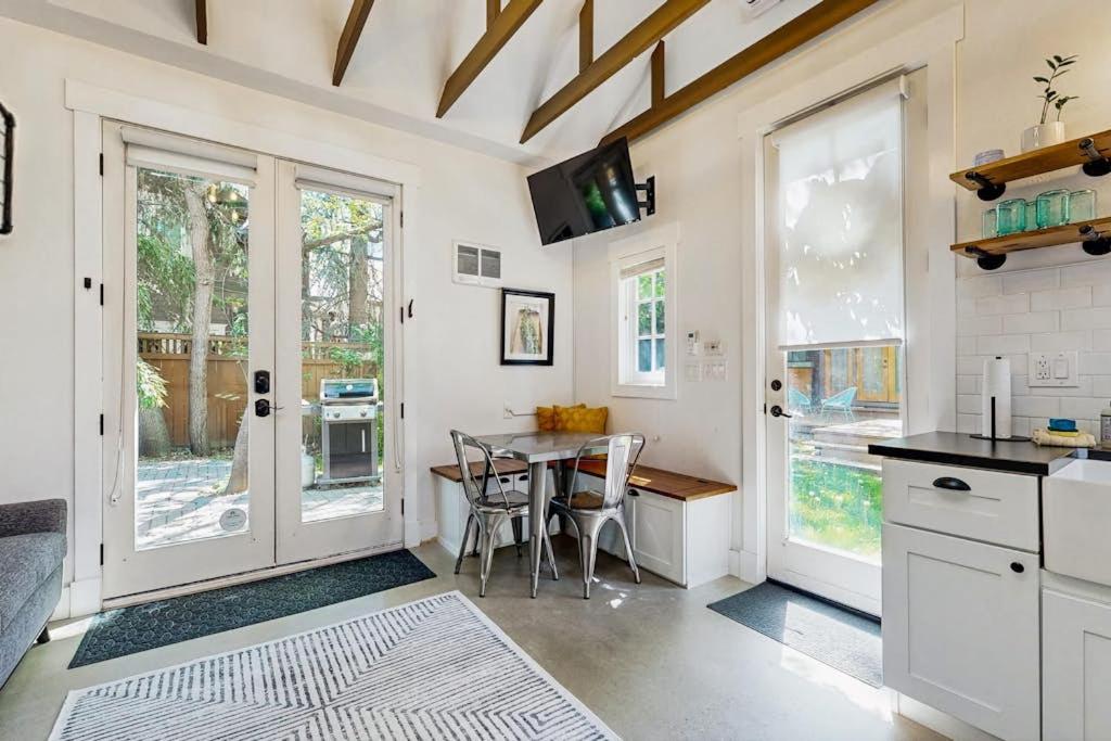 a kitchen with a table and a dining room at Charming Tiny Home in Boise's North End in Boise