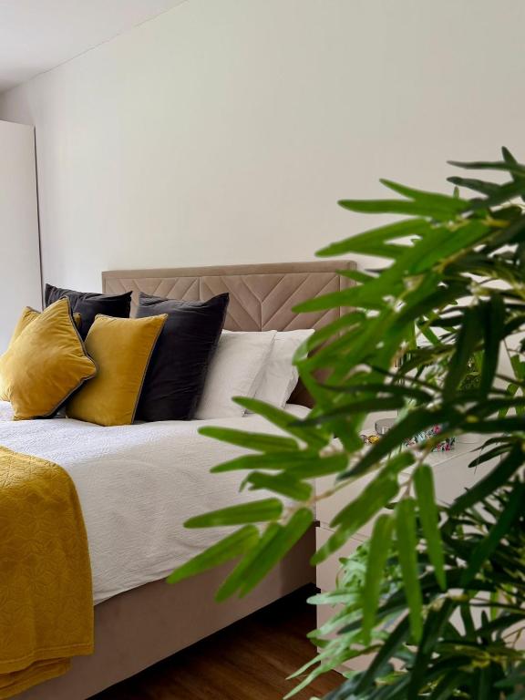 a bedroom with a bed with yellow and black pillows at Forest Path Apartment Quiet Countryside Retreat with Sauna, Sleeps 4 in Ballynahinch