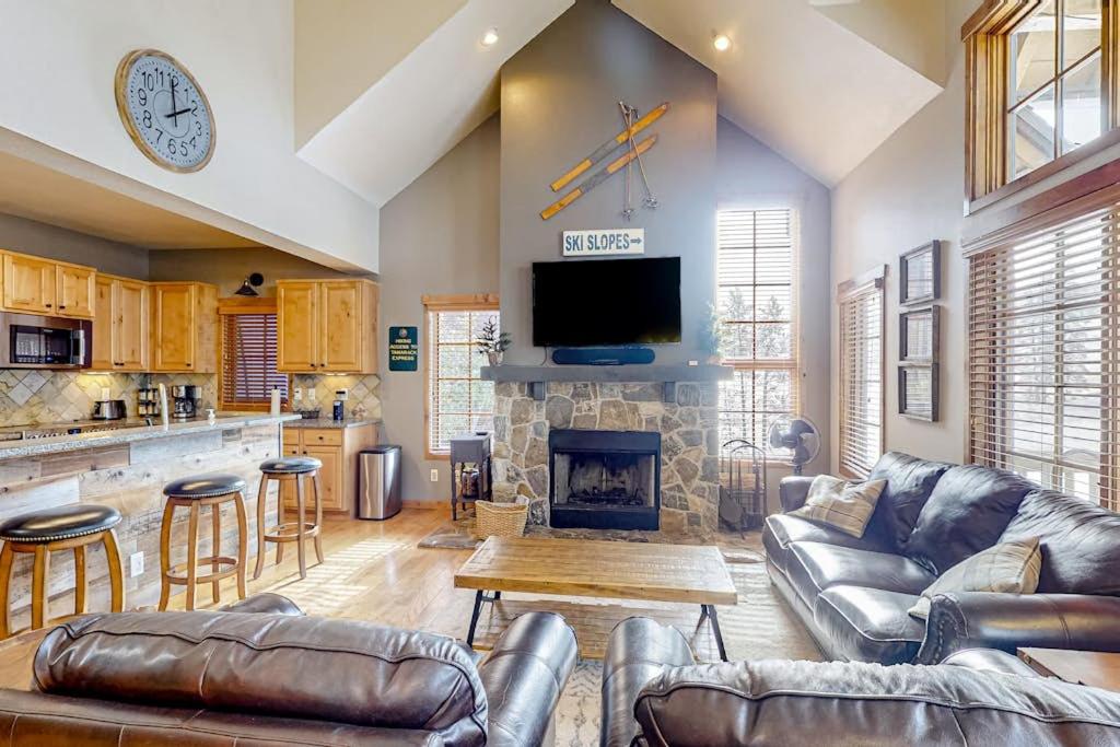 a living room with leather furniture and a fireplace at Need for Speed in Donnelly