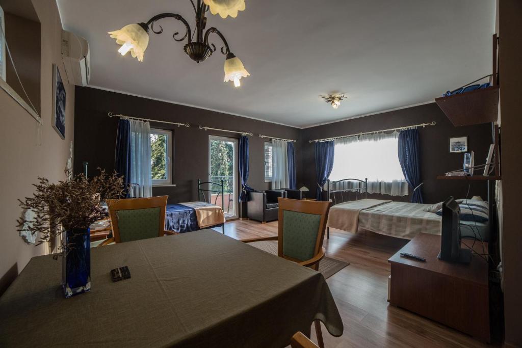 salon ze stołem jadalnym i sypialnia w obiekcie Villa Lugano w Rovinj