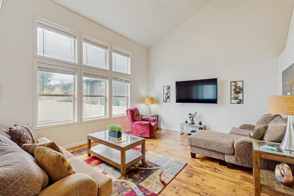 a living room with two couches and a tv at Park View Townhouse in Boise