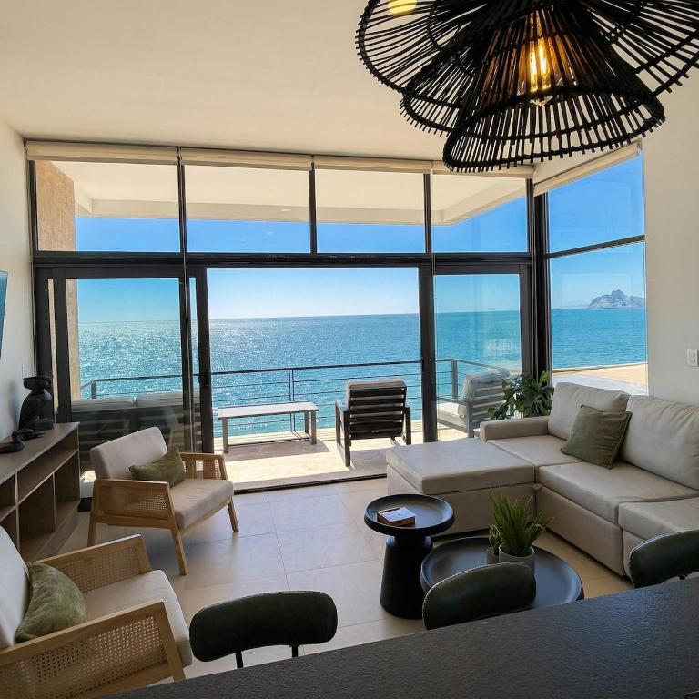 a living room with a view of the ocean at Kocoy Oceanfront condo in Punta Peninsula in Bahía Kino