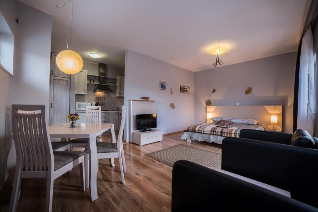 salon z łóżkiem i stołem oraz sypialnia w obiekcie Villa Lugano w Rovinj
